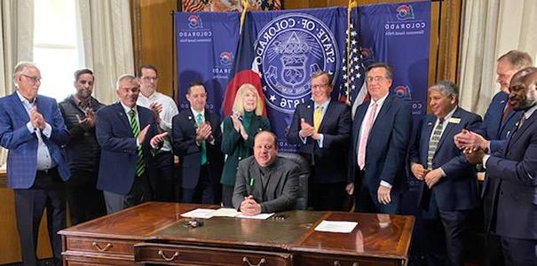 Governor Polis signing Senate Bill 56