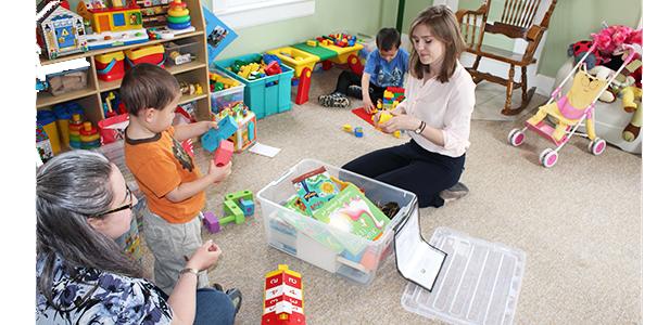 Student working with children and their mother.