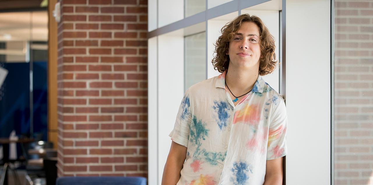 Parker Coffelt standing against a wall 