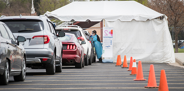 Line of cars for drive-thru testing site on campus